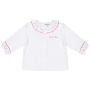 camisa de bebé blanca con volantes en cuello y puños con detalles en rosa